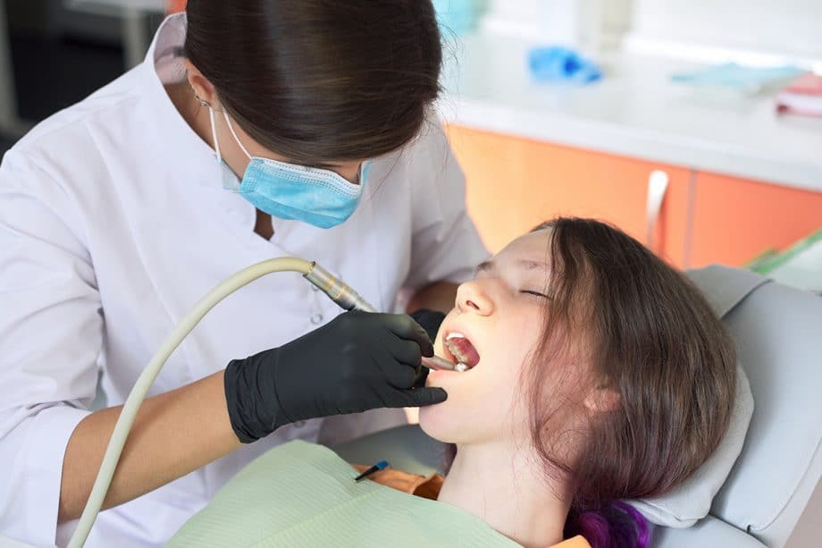 a dentist treats a relaxed patient